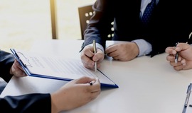 Two people looking over contract